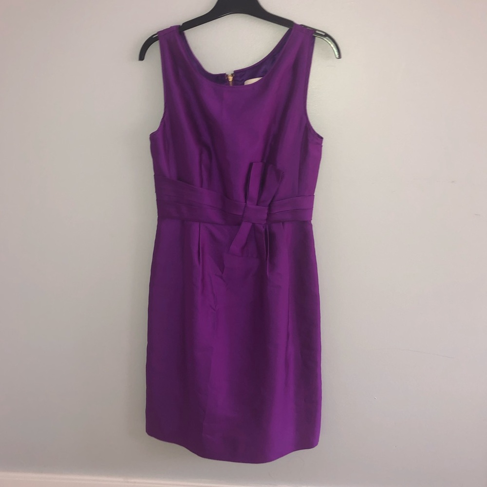 It’s a cute purple dress with a bow on the front